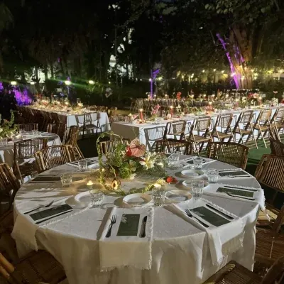 Tables set for an evening reception under the palms