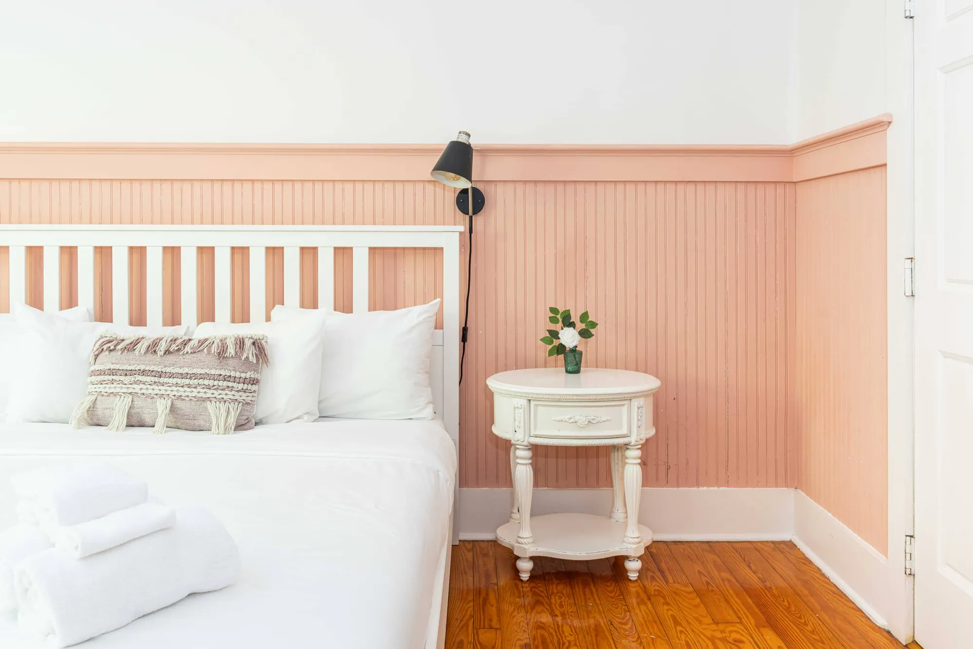Twin beds against a coral-striped wall
