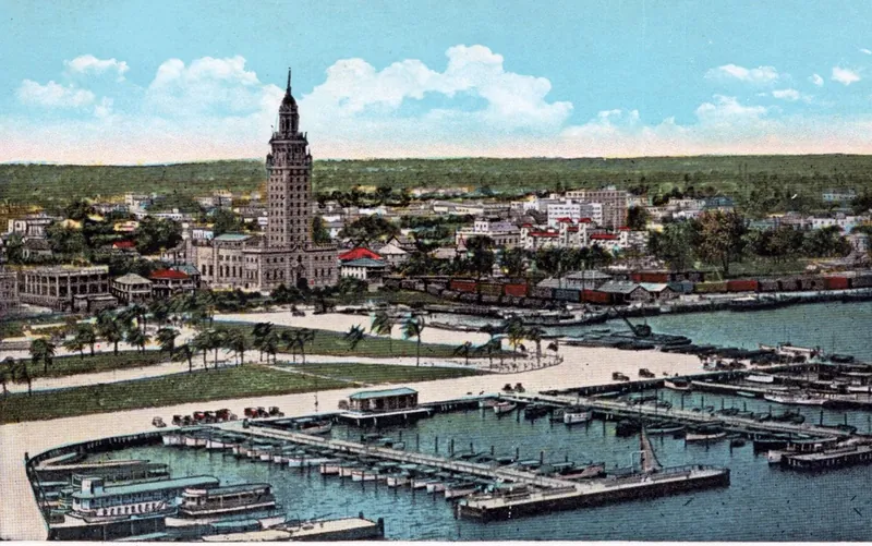 A 1920s postcard - a Miami yacht basin full of boats, the Daily News Tower rising behind