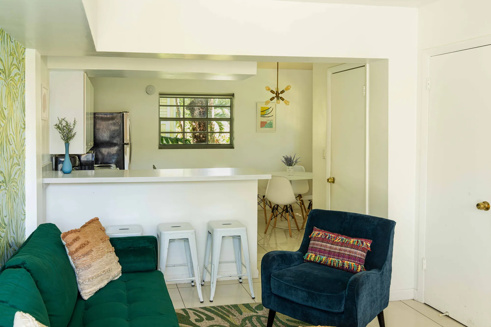 Lounge and kitchen with a green sofa