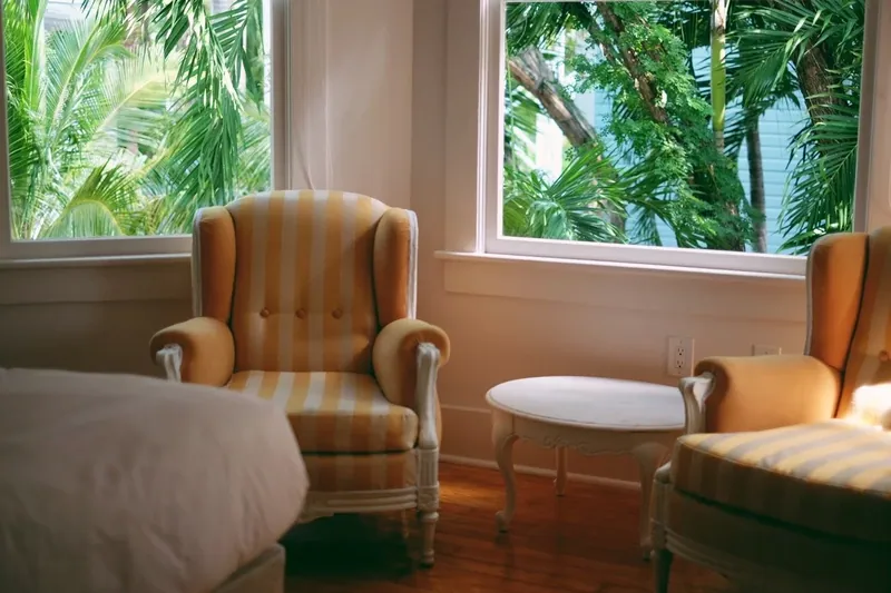 Armchair set beside a restored sash window