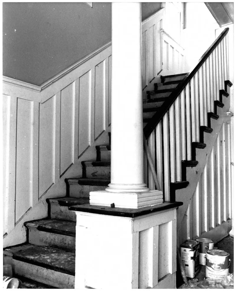 Framed photograph beside the historic staircase
